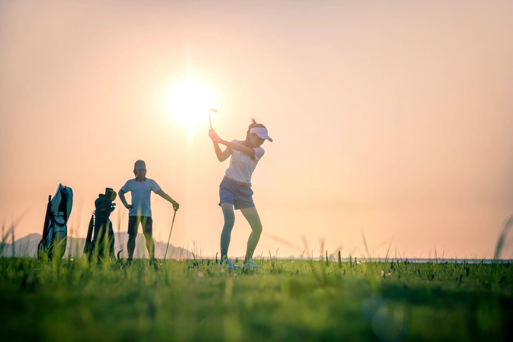 Woman golfer hits a wedge shot