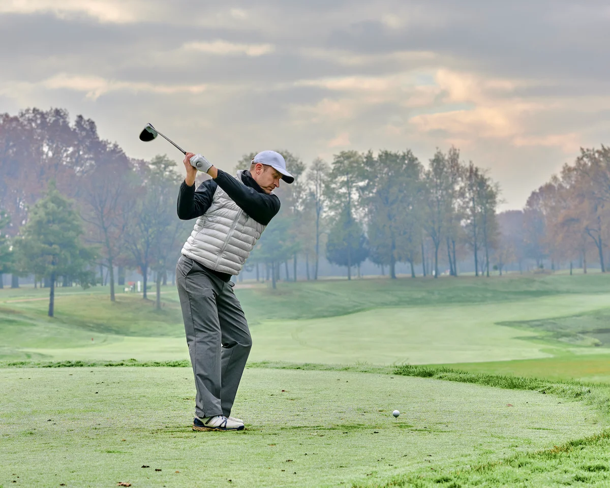 Golfer's backswing on tee box