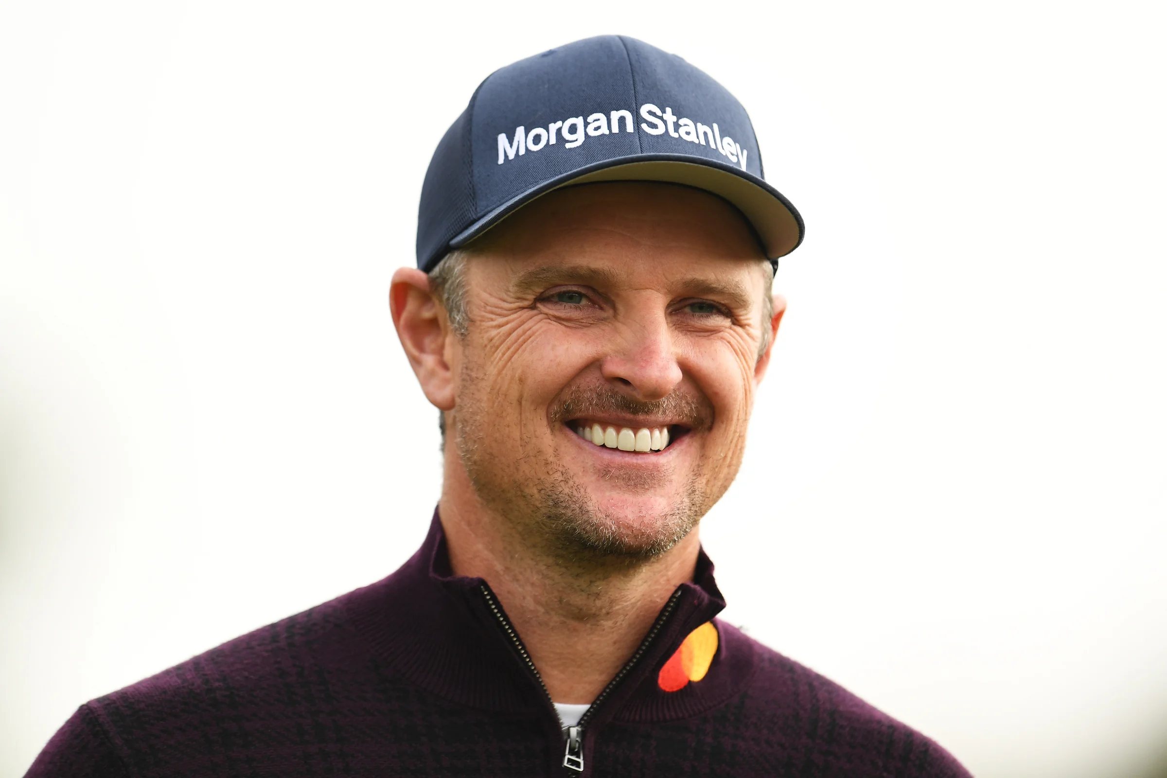 Justin Rose smiles in April 2022
