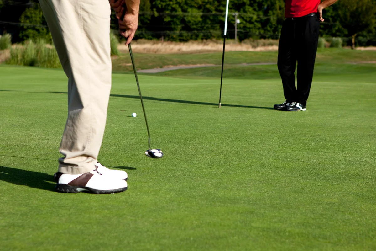 Two people putting on green