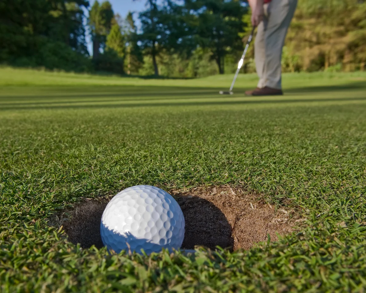 Golfer sinking long putt