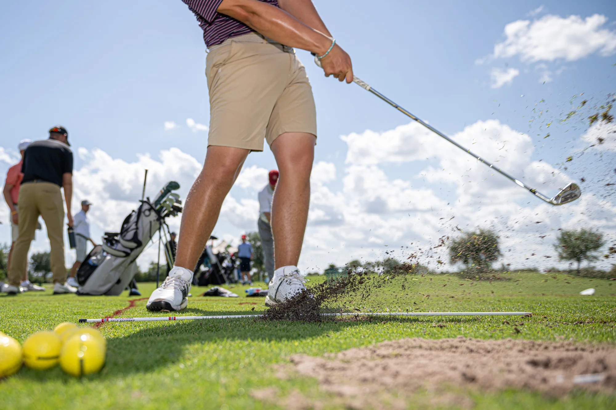 Golfer working on inside out path at the driving range