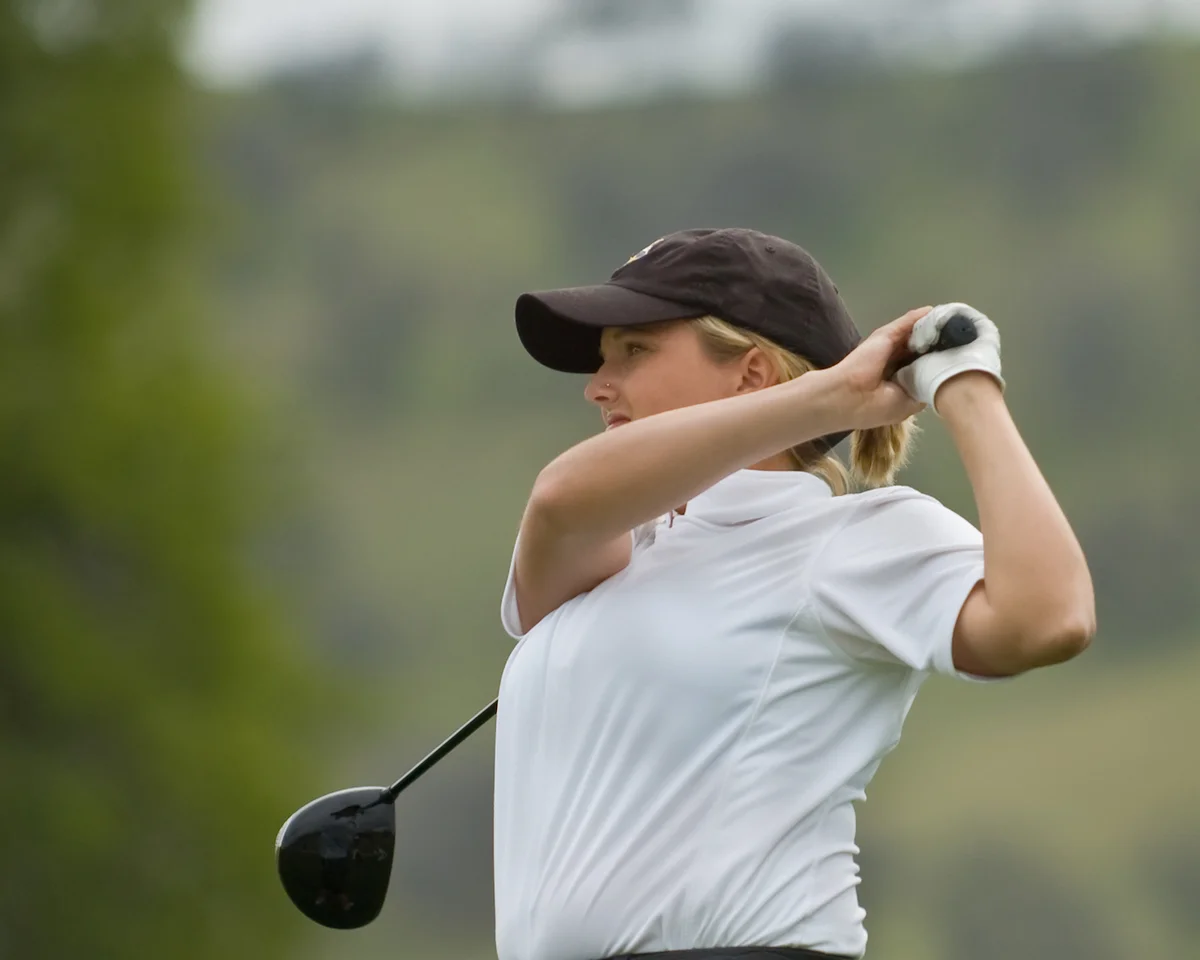 golfer watching tee shot and target