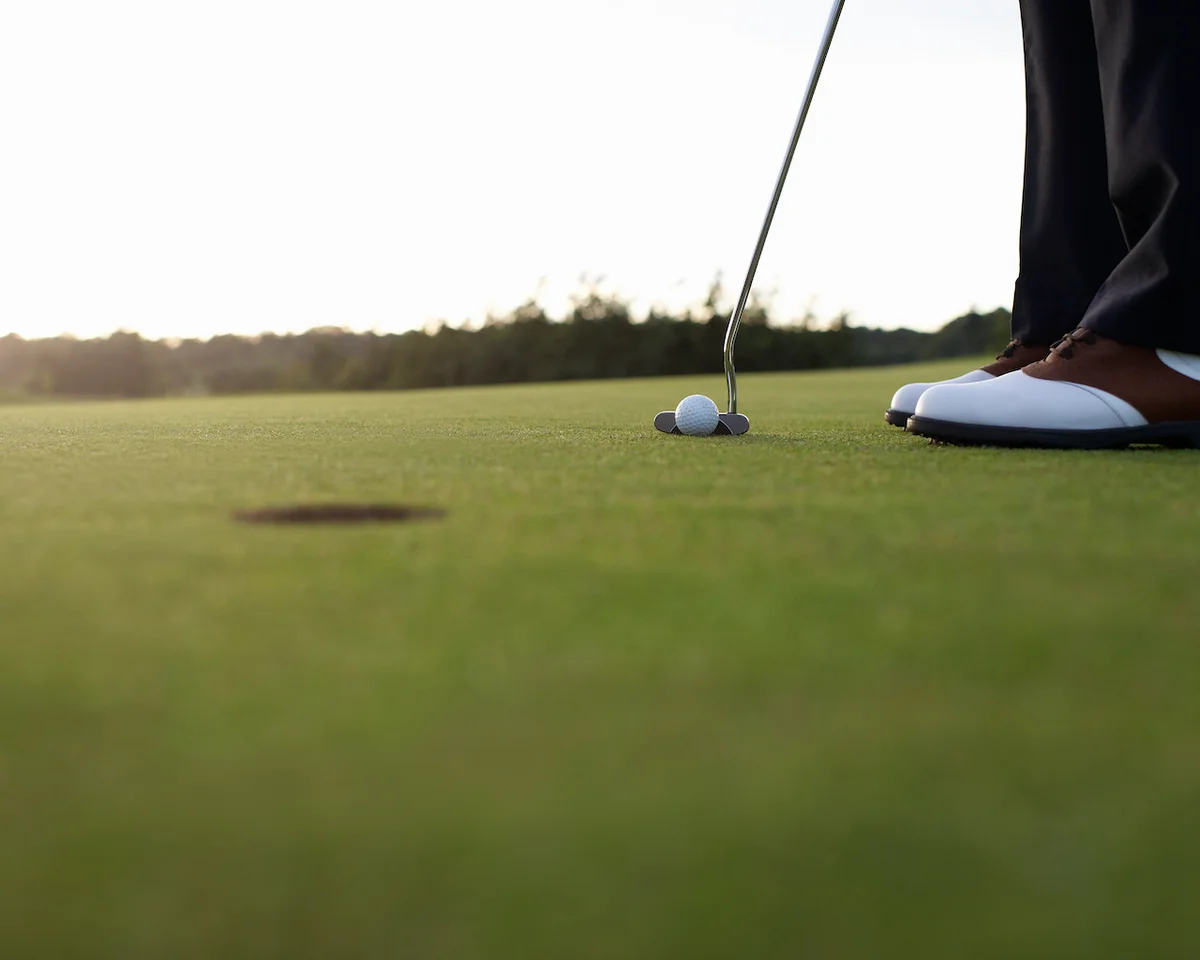 Golfer about to putt on green