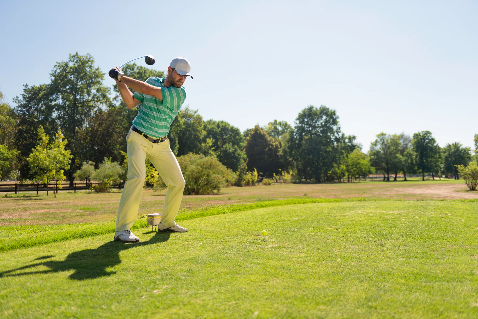 Golfer hits a fade with driver