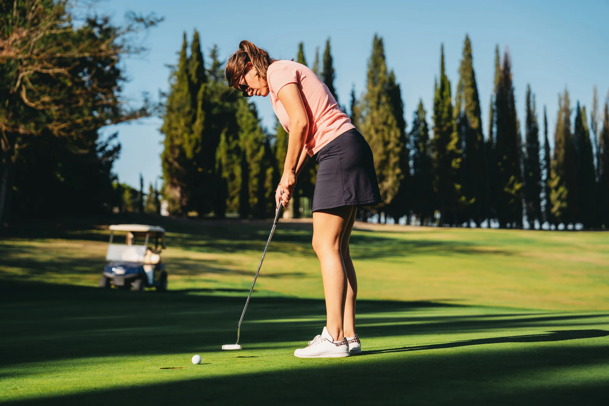 Golfer making a putt with the perfect length putter