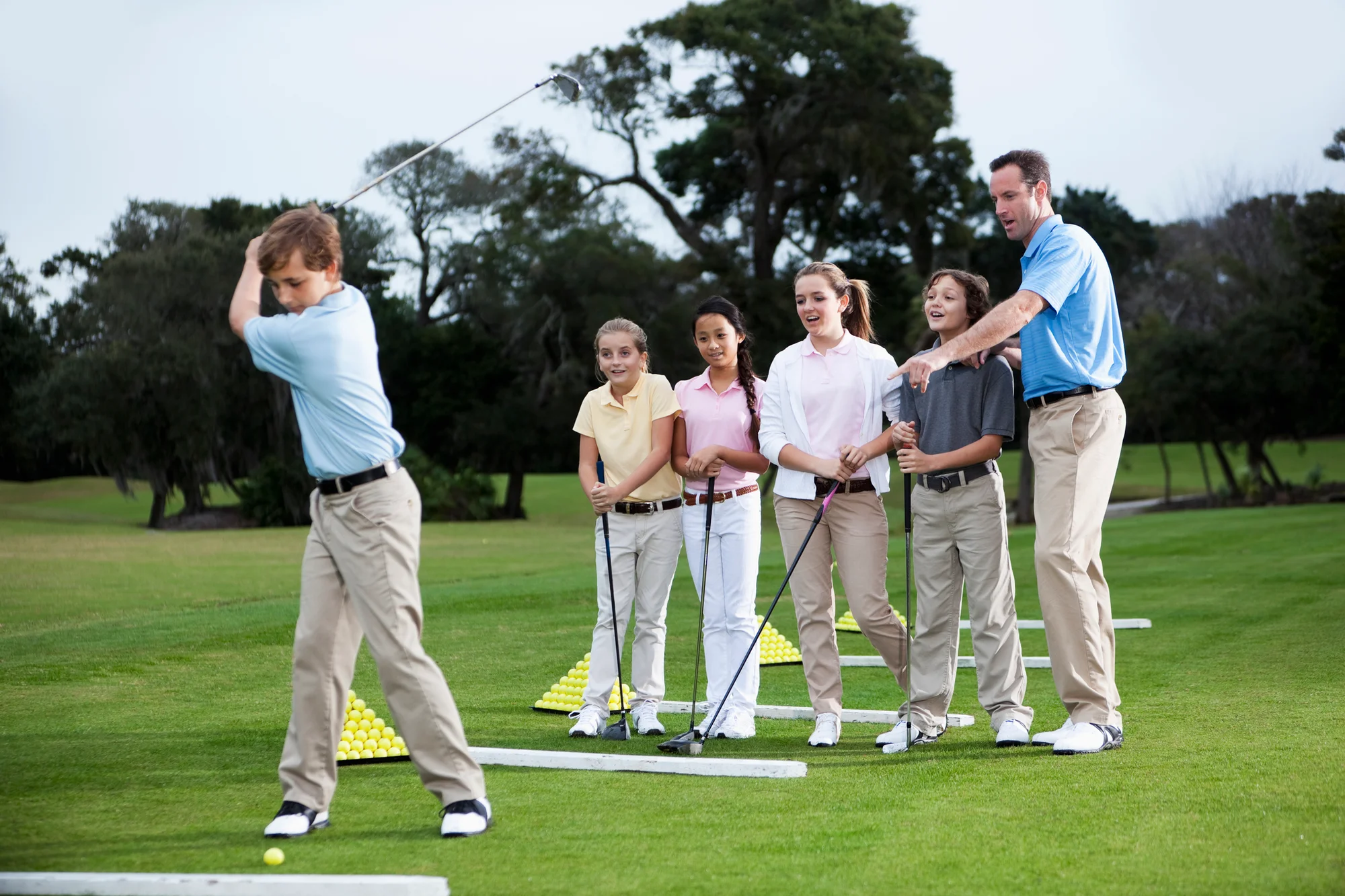 Head golf professional leading a youth clinic