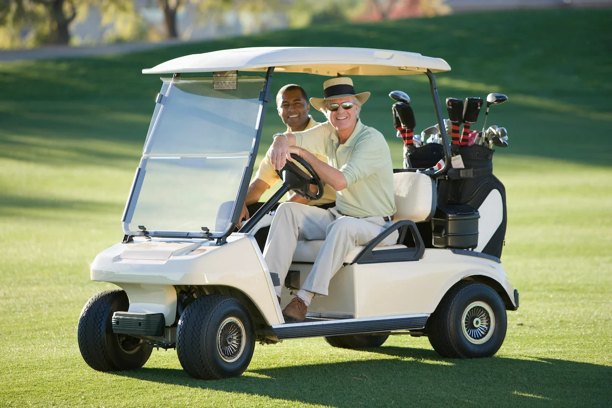 golfers riding in golf cart