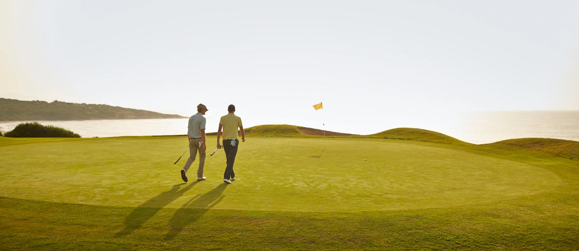 Two men playing golf quickly