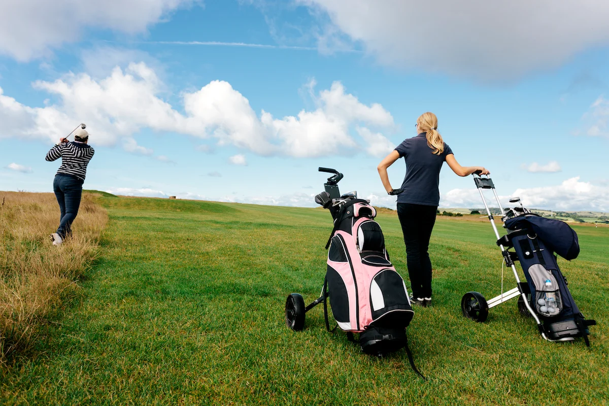 Golfers using push carts on course