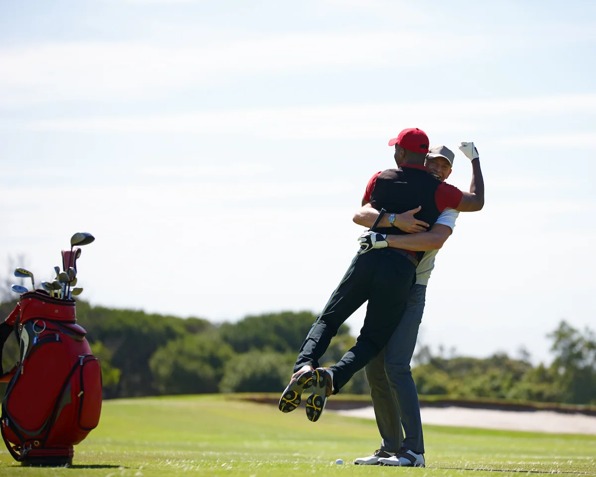 Golfers celebrating hole in one