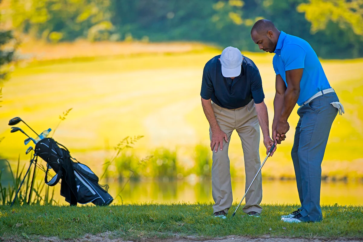 Golfer receiving swing lessons