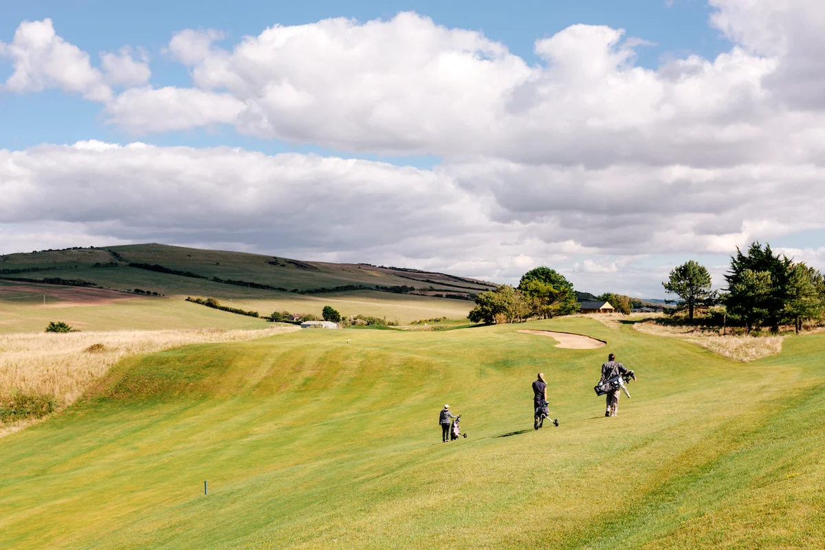 Golfers walking on course 18 holes