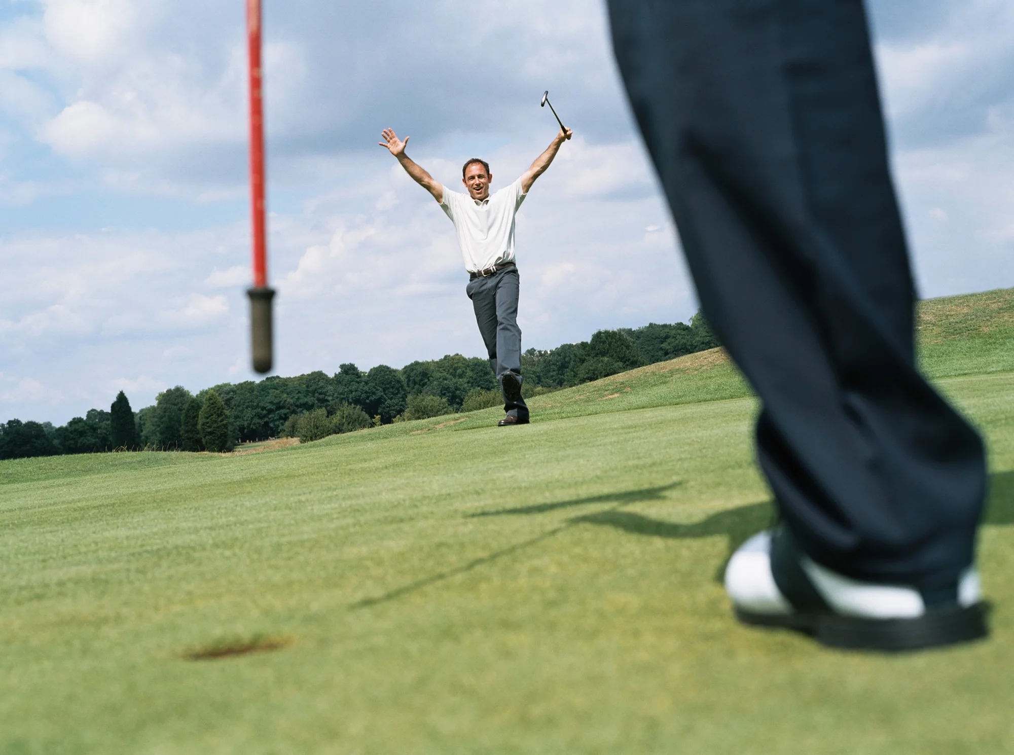 Golfer celebrates making a putt