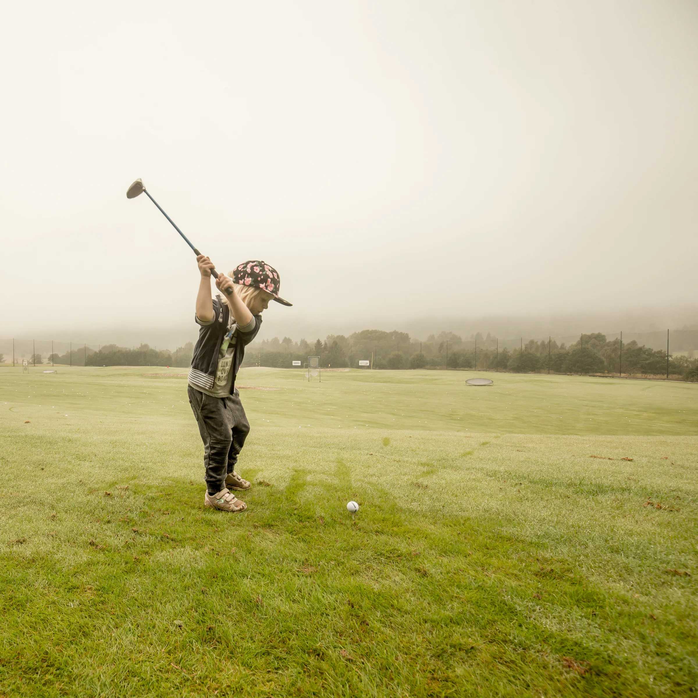 Child golfer at the driving range