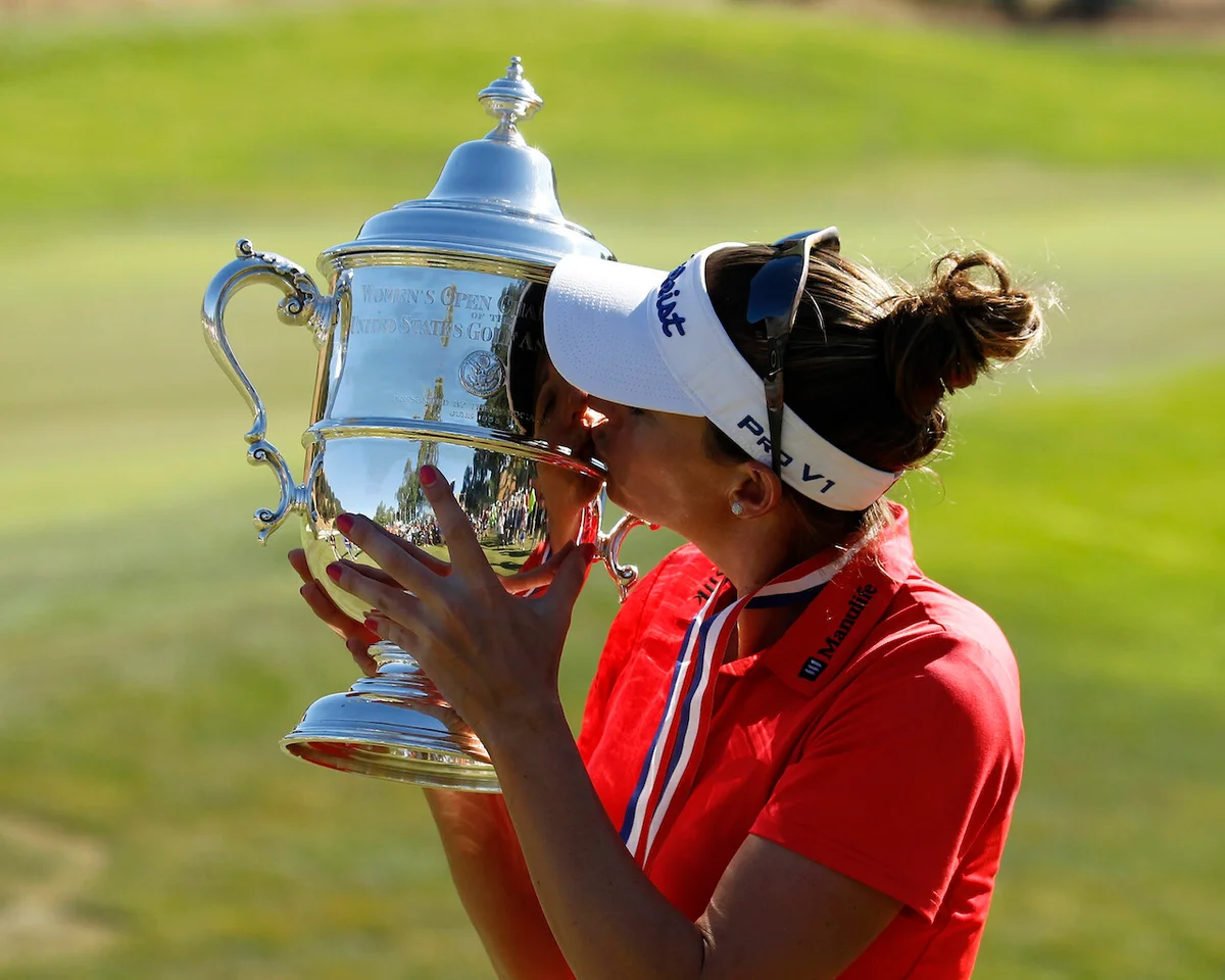 Brittany Lang kisses Harton S. Semple Trophy