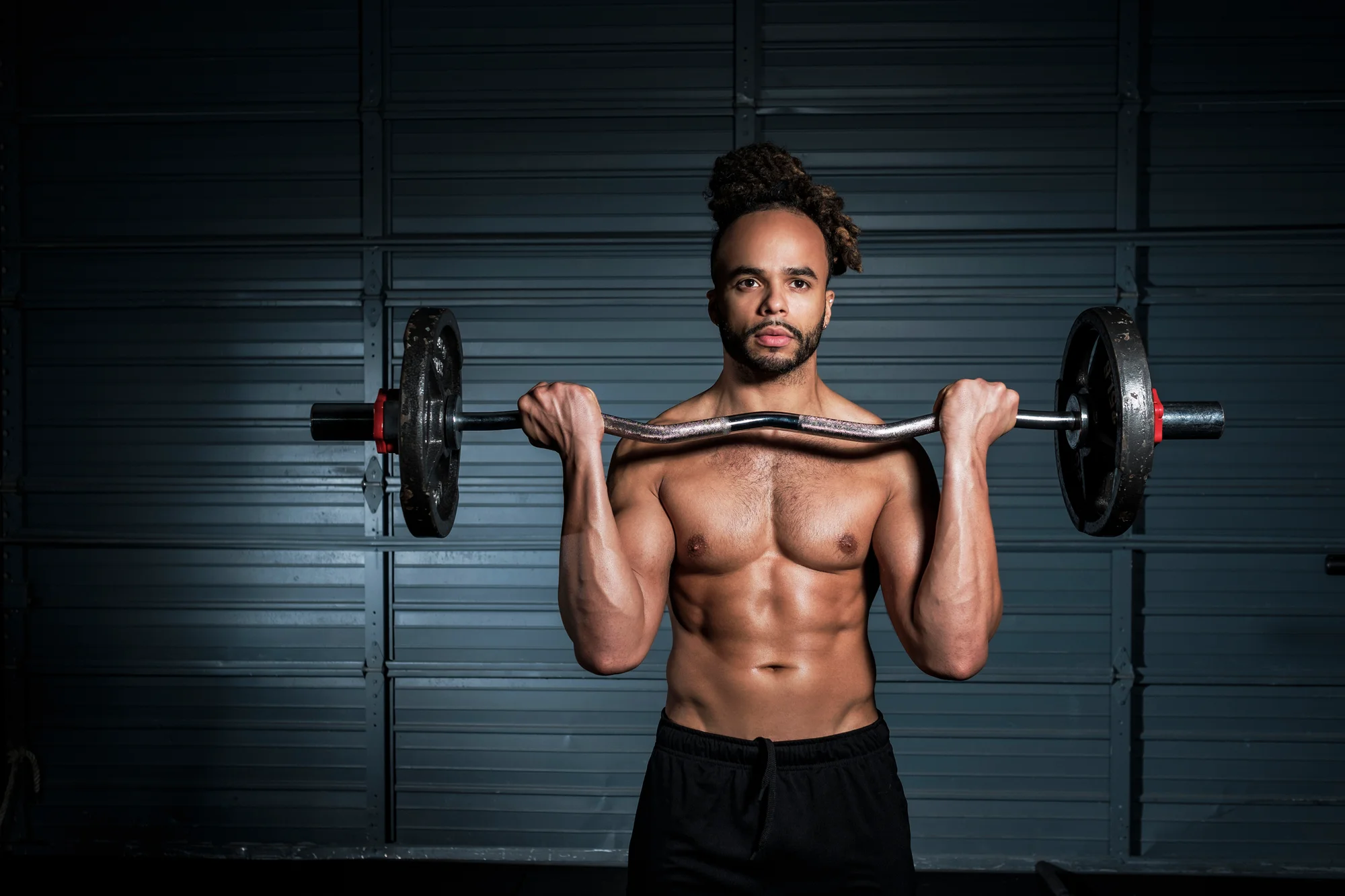 Man doing bicep curl with barbell