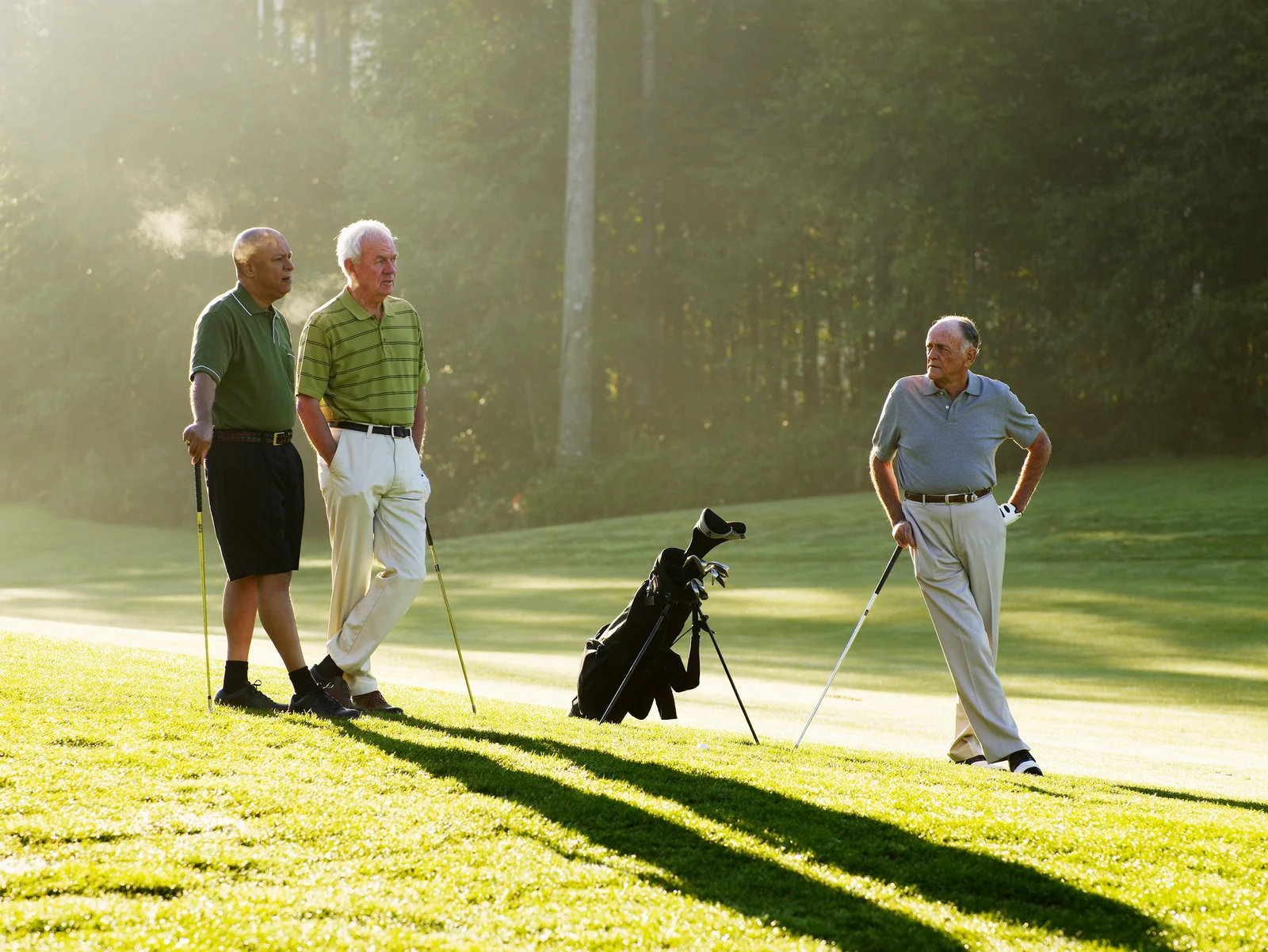 Men waiting to tee off on a crowded golf course