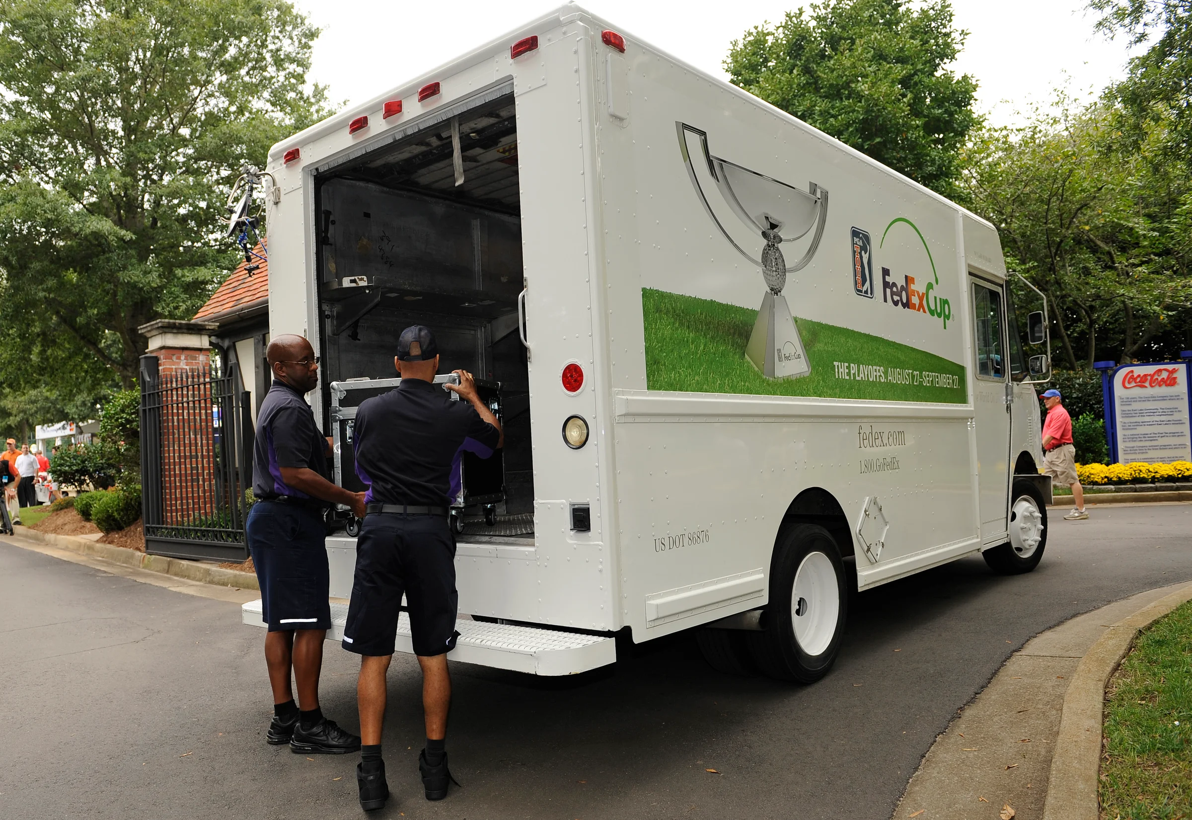 FedEx workers unload at a golf tournament