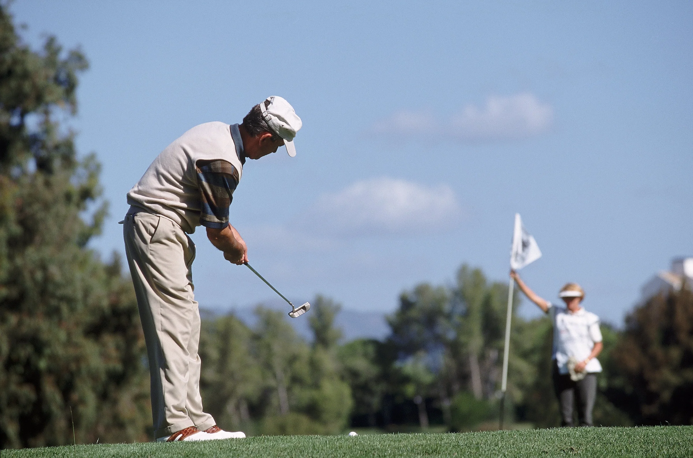 Golfer hits a Texas wedge from the fringe
