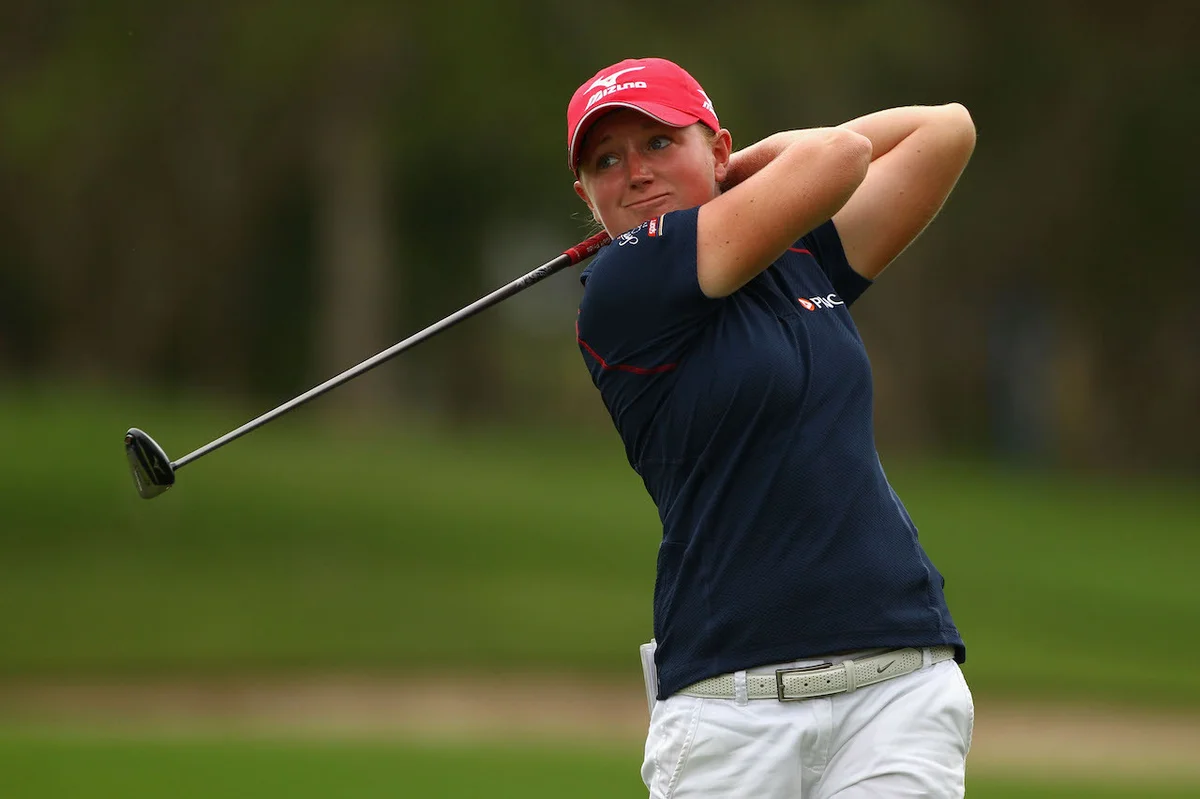 golfer using fairway wood