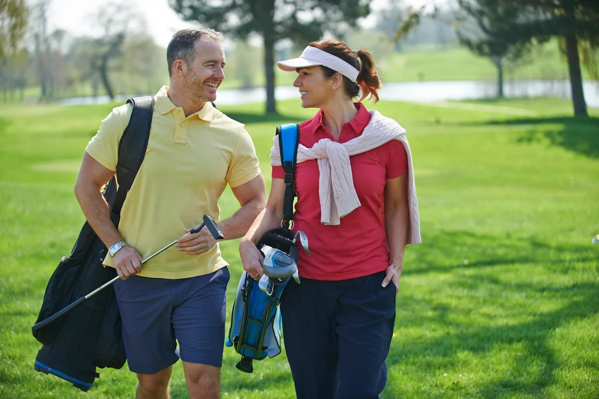 Golf couple with clubs