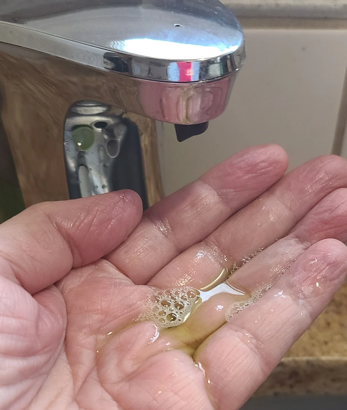 No-touch soap dispenser in use by Jan G. 