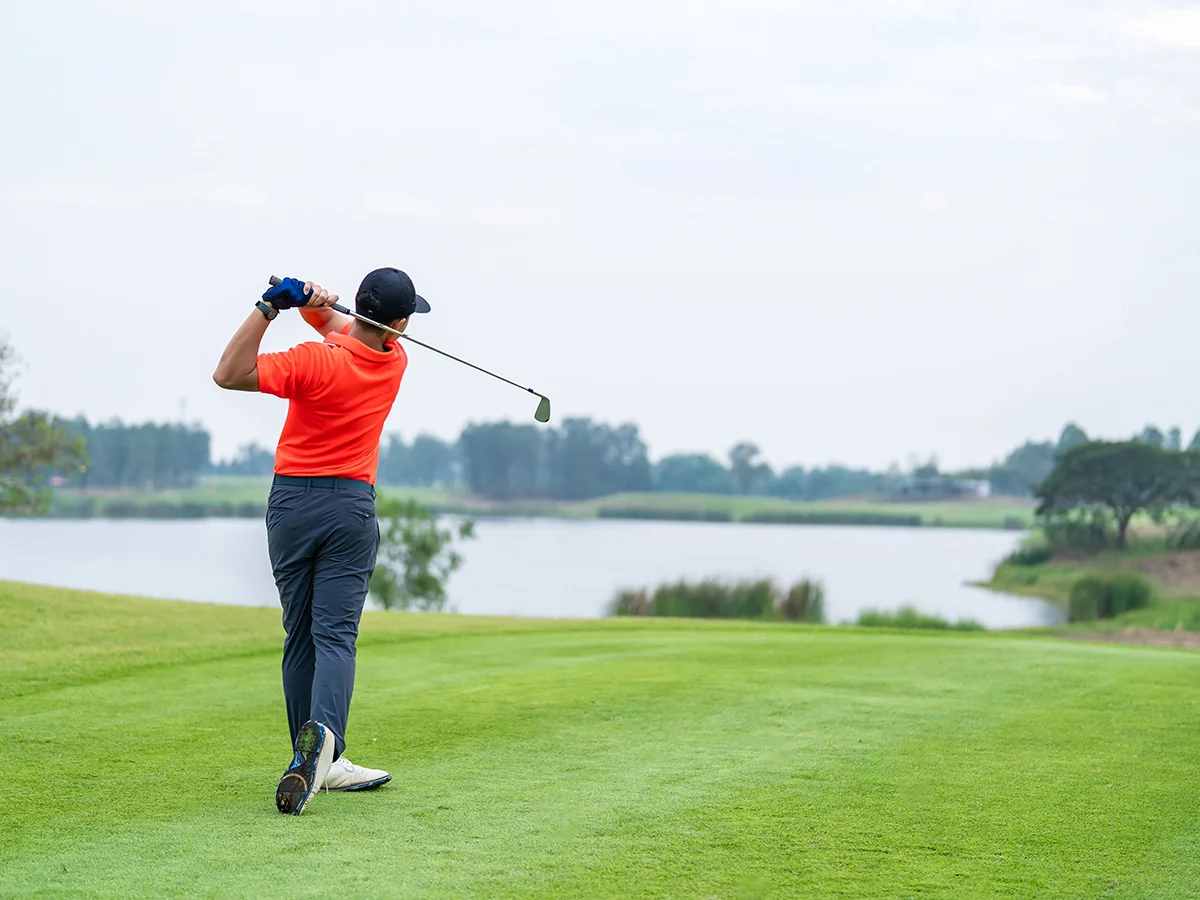 Golfer holds his finish after a golf swing