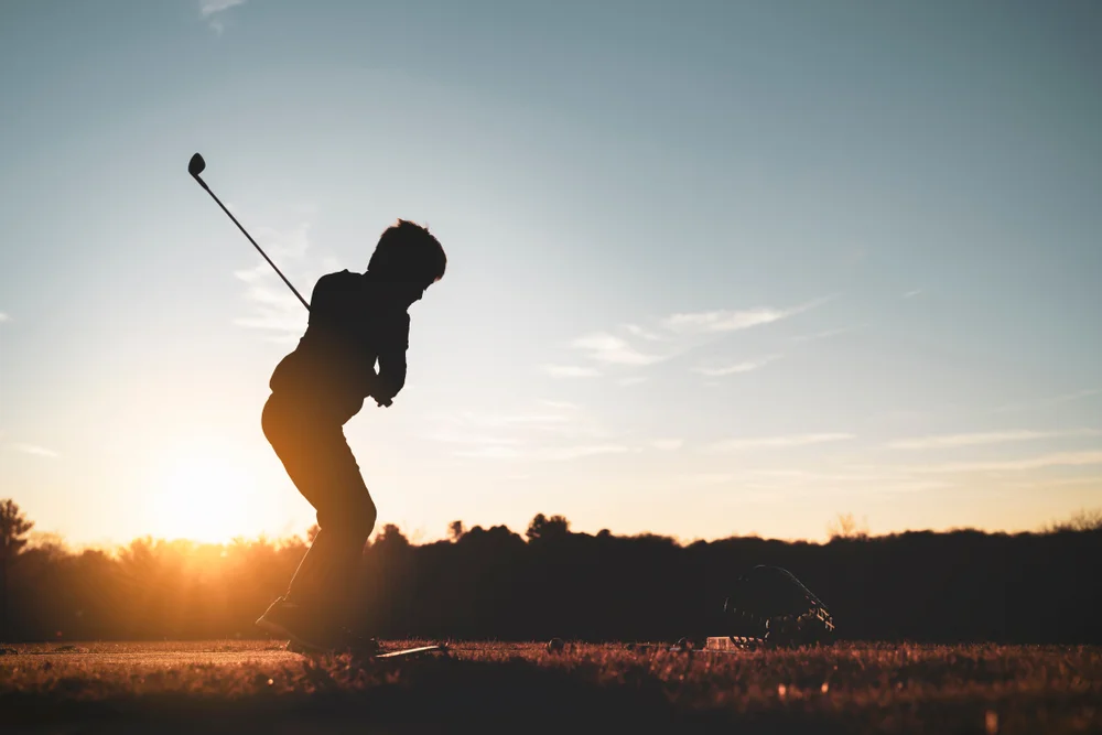 Golfer shallowing the club on the downswing