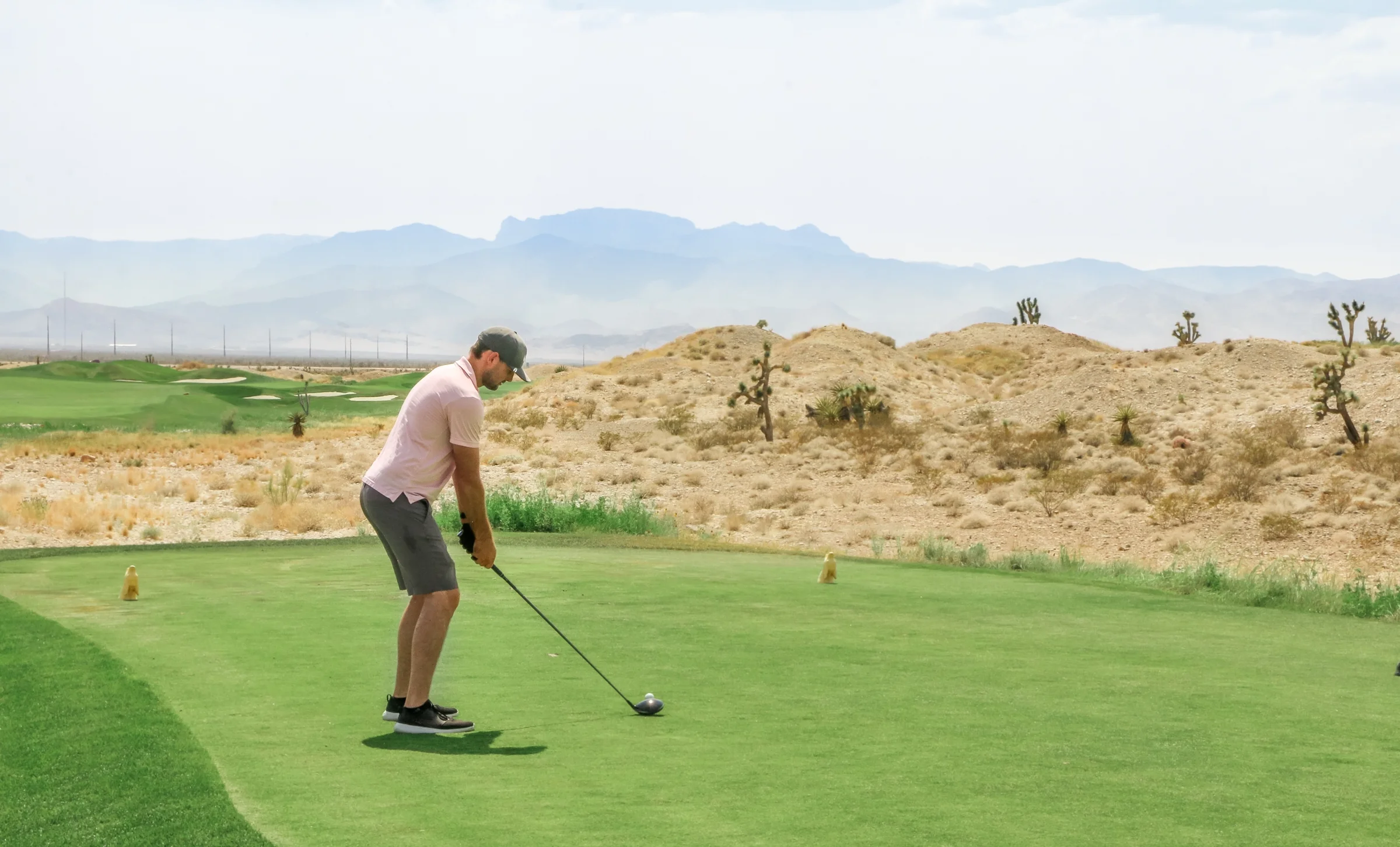 Golfer teeing off hitting a draw