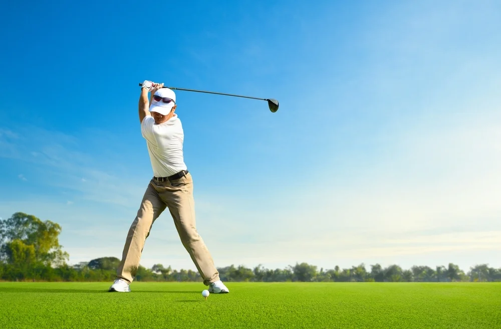 Golfer hitting driver with ideal ball position
