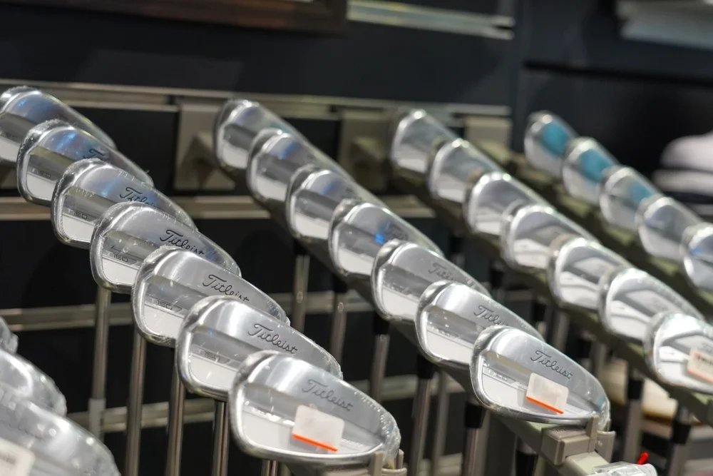 Sets of forged golf irons on a retail shelf